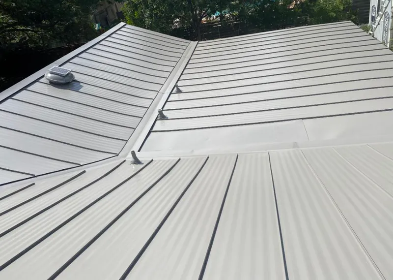 Solar attic fan installed on a metal roof for Roof Ventilation in Raceland